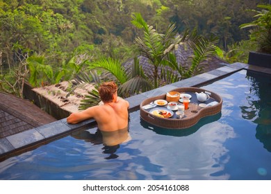 Floating Food Tray. Man At Pool Side Above Jungle