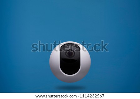 floating home security camera 360 on blue background