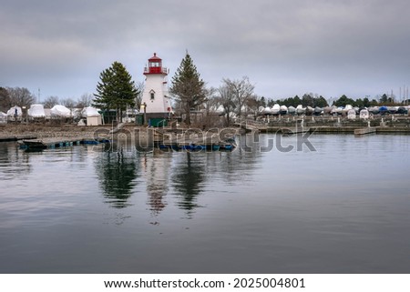Floating Light House between clouds and water. Photo is taken on March 25, 2021 at 1391 Lake Shore Blvd W, Toronto, ON M6K 3C1, Canada. 

