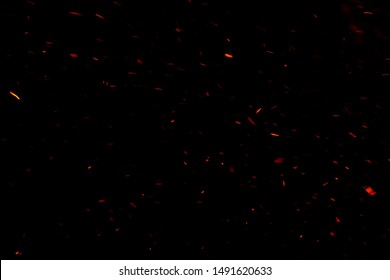 The floating light and sparkle of the fire in the dark background. - Shutterstock ID 1491620633