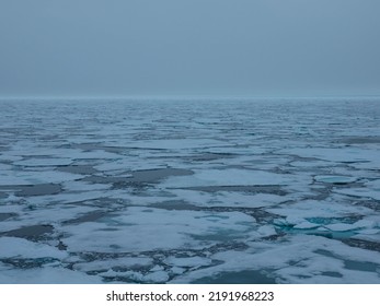 Floating Pack Ice in the arctic ocean. The snow covered blue glacial ice is an unspoilt wilderness but is fast melting due to climate change. Nordaustlandet, Svalbard, Norway