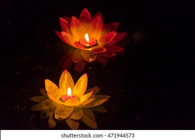 Floating Paper Lanterns On The Water At Night