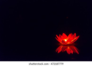 Floating Paper Lanterns On The Water At Night