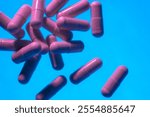 Floating Pink Medication Capsules on Blue Background