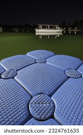 Floating plastic structure on the surface of a lake at night