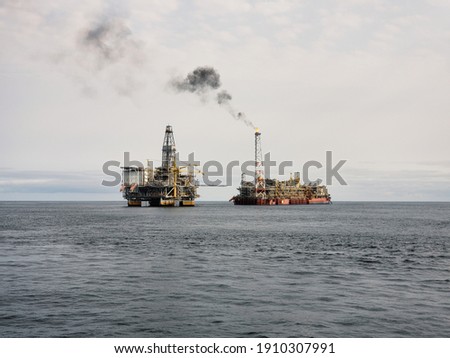 Floating production storage and offloading (FPSO) vessel with Oil Platform, oil and gas industry. Production is in progress. View from ship