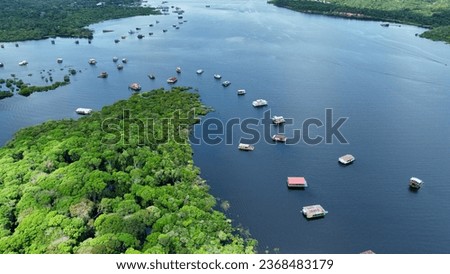 Floating restaurants of Amazon River at Amazon Forest. Manaus Brazil. Nature wild life landscape. Green background. Forest trees at Amazonas state. Tourism attraction. Travel destination.