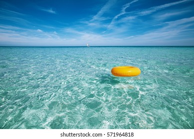 floating ring on blue clear sea and sky, shallow dof - Powered by Shutterstock