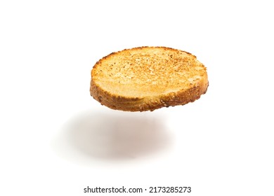 A Floating Slice Of Fried Bread On A White Background. Round Flying Toast. Isolated.