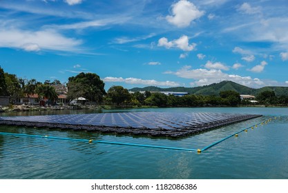Floating Solar Farm or Solar panels on  the river with blue sky and mountain is the background.