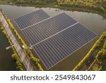 Floating solar panels on a river, part of a hydroelectric power plant using renewable energy for industrial electricity.