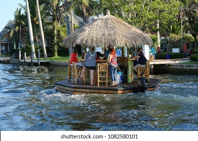 Floating Tiki Bar Cruises Down The Intracoastal Waterway In Fort Lauderdale, Florida, USA. 