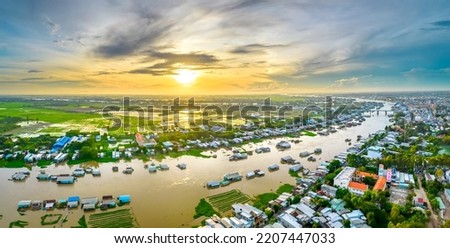 Floating village along Hau river at dawn in the sky over Vietnam border area, aerial view. The river basin contains a lot of seafood and alluvium for agriculture and economic development in the Mekong