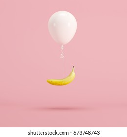 Floating White Balloon And Banana On Pink Background. Minimal Fruit Idea Concept.