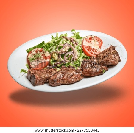 Floating White plate with lamb chops and salad  on orange gradient background Stock photo © 