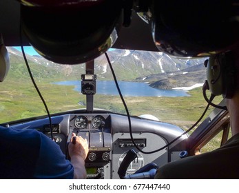 Floatplane landing on Alaskan mountain lake - Powered by Shutterstock