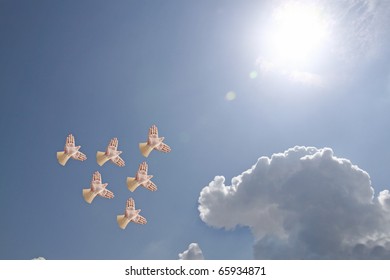 A Flock Of Hand Shadow Puppet Shaped Like Birds Flying Into The Sun.