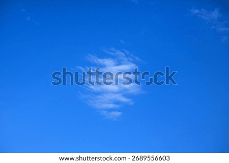 FLOCKY WHITE PATCH OF CLOUD IN AN AZURE BLUE SKY