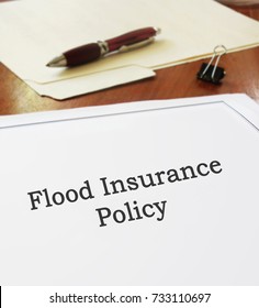 Flood Insurance Policy On An Office Desk                               