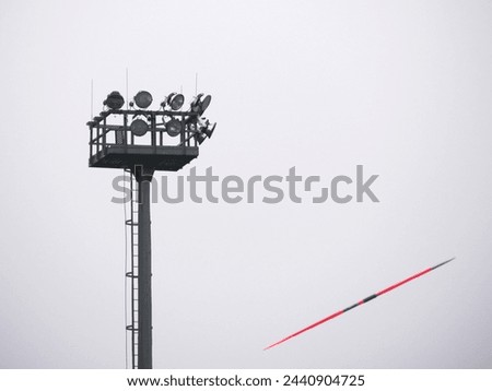 flood light post and a red flying javelin