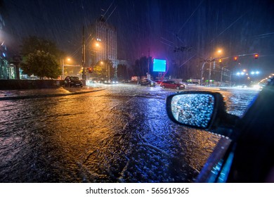 Flood on the road at night - Shutterstock ID 565619365