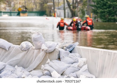 Flood Protection Sandbags with flooded homes in the background (Montage) - Shutterstock ID 705371167