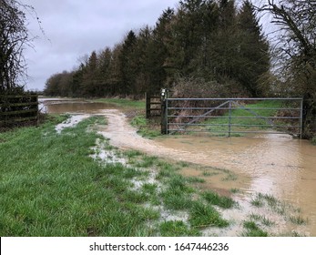 Flood water in fields, UK countryside. Winter storms causing flooding and wind damage to crops on Oxfordshire agricultural fields.