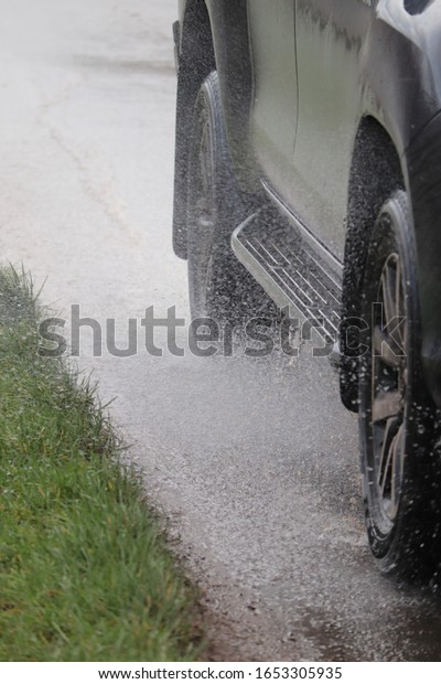 Flood waters\
February 2020 road flooded , vehicles splash spraying water on road\
surface .rugby Warwickshire\
flooding