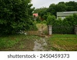 Flooded allotment garden next to houses as a result of local flooding caused by sudden rainfall