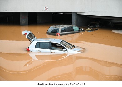 Flooded cars on parking. River floods in the city. Cars submerged in water. Sunken car.