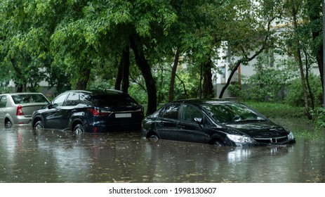 Flooded cars on the street of the city. Street after heavy rain. Water could enter the engine, transmission parts or other places. Disaster Motor Vehicle Insurance Claim Themed. Severe weather concept - Shutterstock ID 1998130607