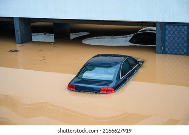 Flooded cars in parking. River floods in the city. Cars submerged in water. Sunken car.