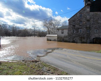 the flooded Conestoga River enters a water powered flour mill; near Leola, PA, USA 
