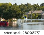 Flooded residential area with underwater houses and cars from hurricane Debby rainfall water in Laurel Meadows community in Sarasota, Florida. Aftermath of natural disaster in southern USA