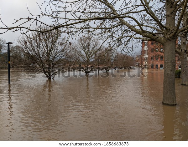 Flooded river and\
car park Worcester with\
trees
