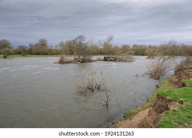 Flooded river with overcast sky - Shutterstock ID 1924131263