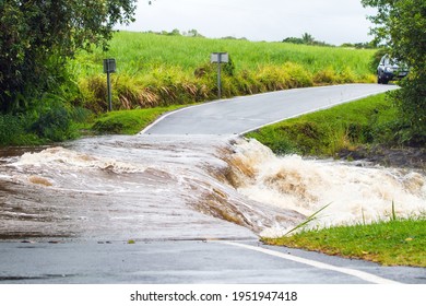 flooded road by an overflowing river, natural disaster