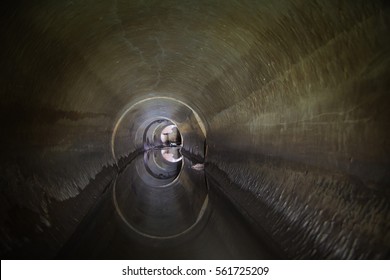 Flooded Round Sewer Tunnel Is Reflecting In Water