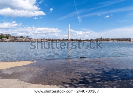 Flooded sidewalks at the tidal basin in Washington DC. A construction project to repair seawalls to prevent flooding is in progress