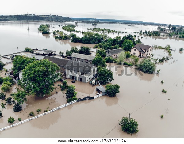 Flooded village on Ukraine. Natural disaster in\
Halych, courtyards and streets in dirty water. Global catastrophe,\
climate change, flood\
concept