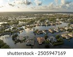 Flooding in Florida caused by tropical storm from hurricane Debby. Suburb houses in Laurel Meadows residential community surrounded by flood waters in Sarasota. Aftermath of natural disaster.