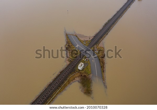 Flooding Germany .Flooded road passing through\
the railway. A road under water.\
