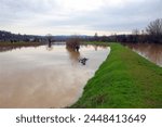 Floodwaters inundate fields after a river breaches its banks during an inundation