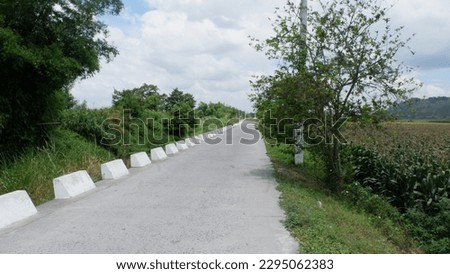Floodway road and river with corn fields in The Philippines 