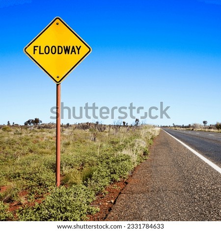 Floodway sign by road in rural Australia.