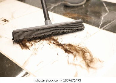 Floor Brush Is Used To Sweep Cut Hair In Salon. Hairdresser Cleaning Concept