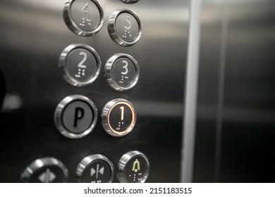 Floor buttons Elevator in an apartment residential building. Buttons of lift panel close-up. Movement, transportation concept. Lots of button on wall. Number on Elevators control panel is lit