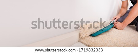 Floor Carpet Fitting Installation. Person Laying Carpet
