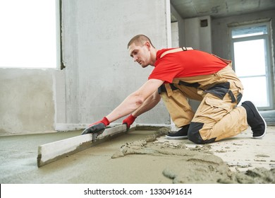 Floor Cement Work. Plasterer Smoothing Floor Surface With Screeder