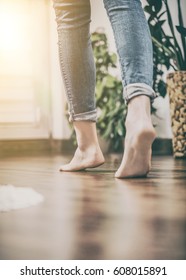 Floor heating. Young woman walking in the house on the warm floor. Gently walked the wooden panels. - Shutterstock ID 608015891